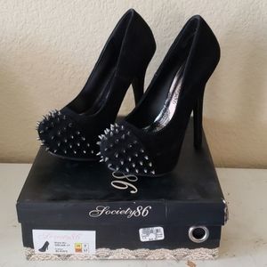 Black suede spiked double platform heels.